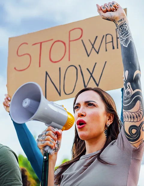 A person speaking through a megaphone at a rally