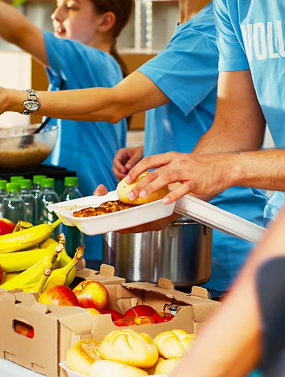 Volunteers serving food at a pantry