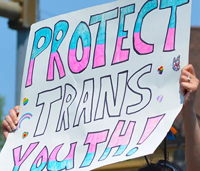 A Protect Trans Youth sign at a community action